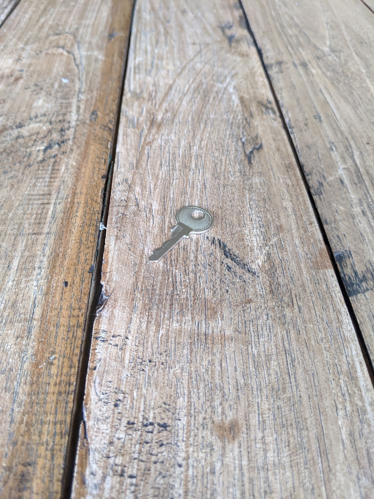 A key on a wooden outdoor pub table